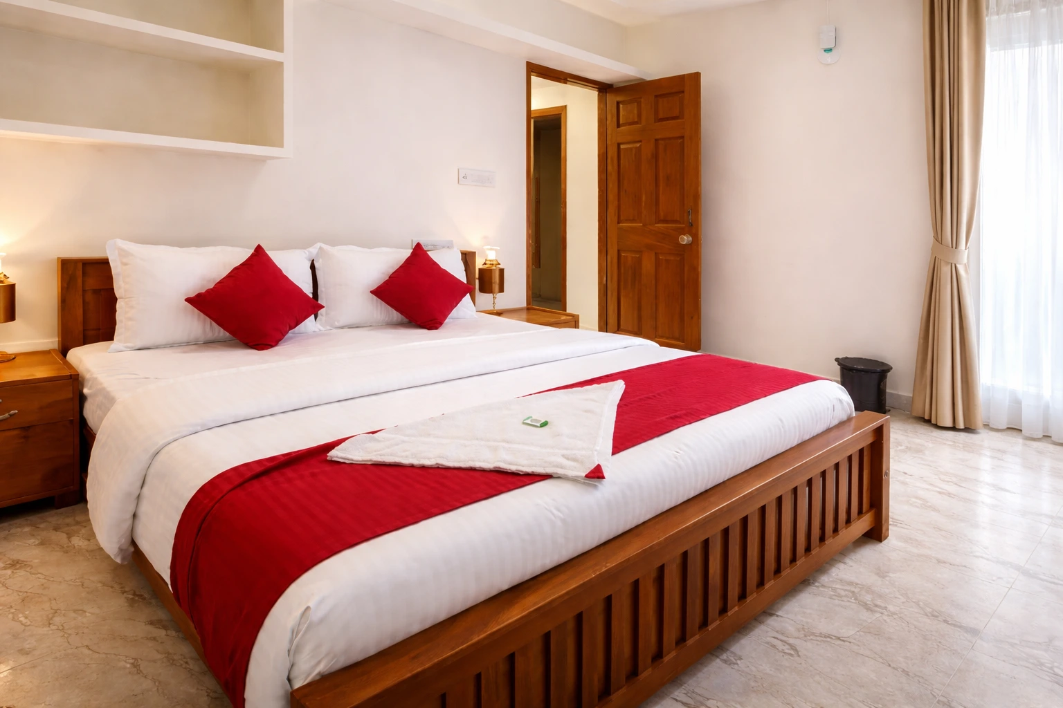 Deluxe room at Aman Residency Adimali with comfortable bed and modern amenities